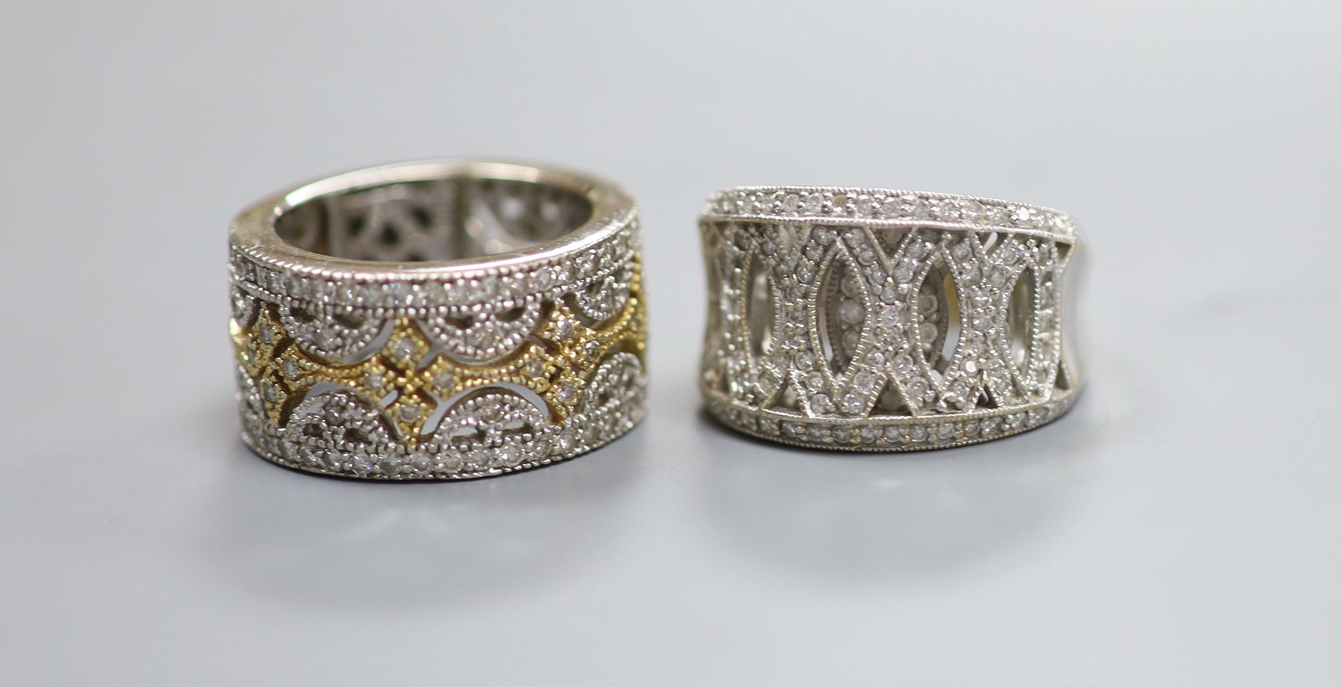 Two modern pierced yellow and white metal, diamond chip cluster rings, sizes K M, gross weight 18.9 grams.